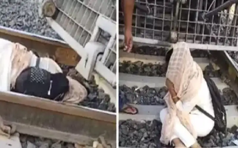 هندية تنام على القضبان خلال محاولة