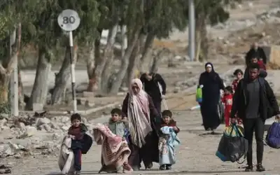 بزي نسائي تحمل حقائب نازحين ..
